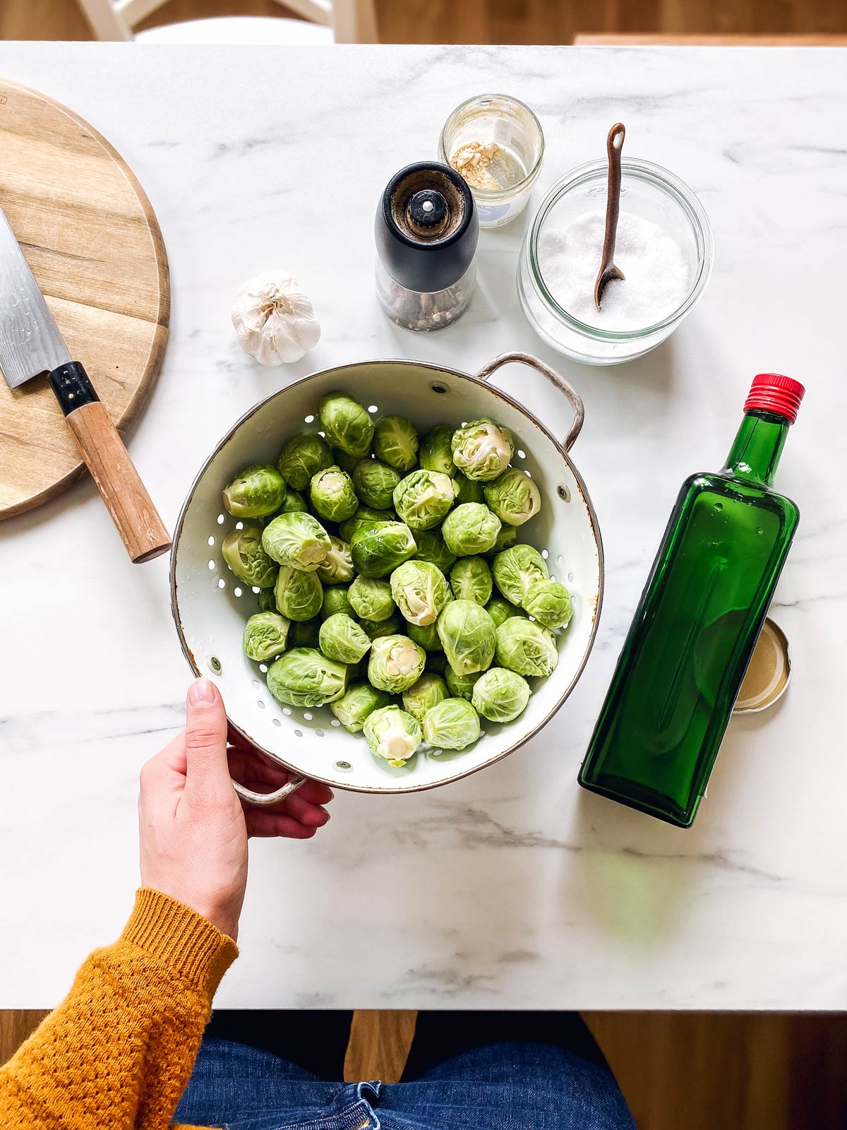 ingredients for roasted Brussels sprouts on a marble counter